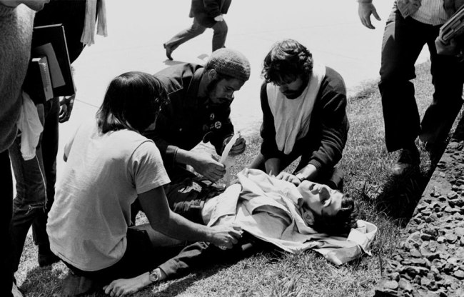 Wounded Kent State student John Cleary is attended to by other s